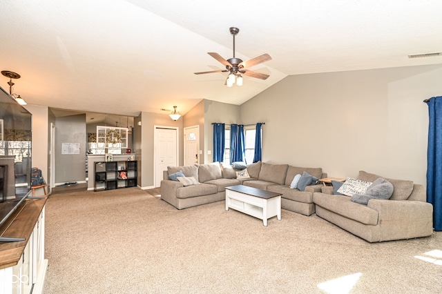 living room with ceiling fan, lofted ceiling, and carpet floors