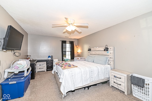 carpeted bedroom with a textured ceiling and ceiling fan