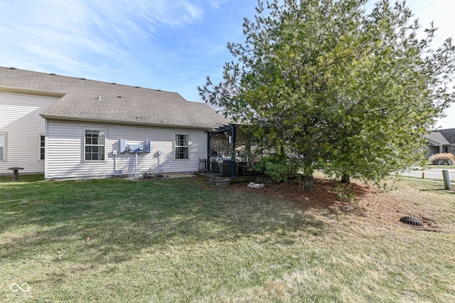 back of house featuring a pergola and a lawn