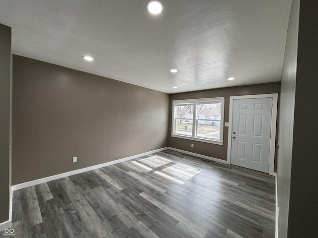 spare room featuring dark wood-type flooring