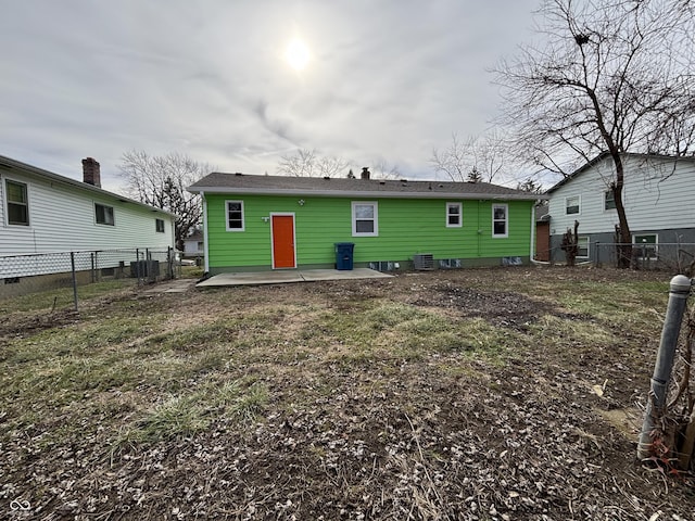 rear view of property with a yard and a patio area