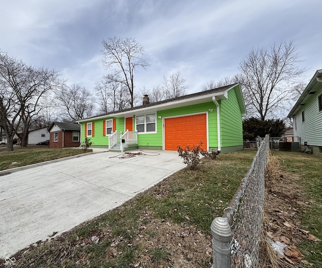 ranch-style house featuring a garage and a front lawn