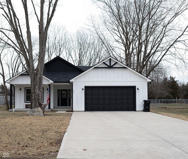 modern farmhouse style home with a garage and a front lawn