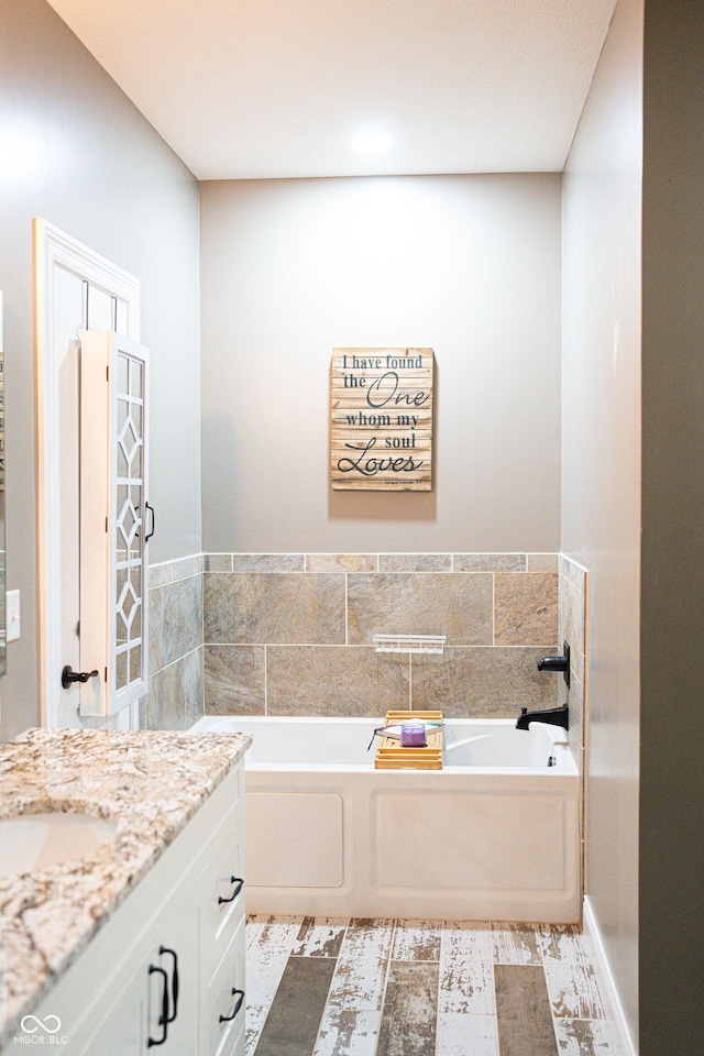 bathroom featuring a tub to relax in and vanity