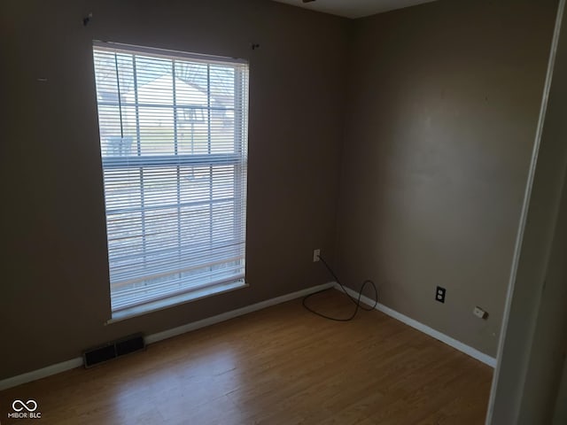 empty room with hardwood / wood-style floors