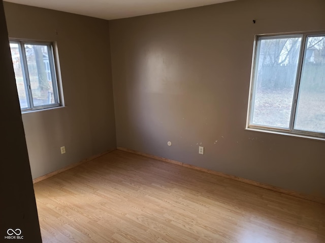 unfurnished room featuring plenty of natural light and light wood-type flooring