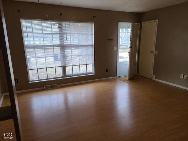 spare room with hardwood / wood-style flooring