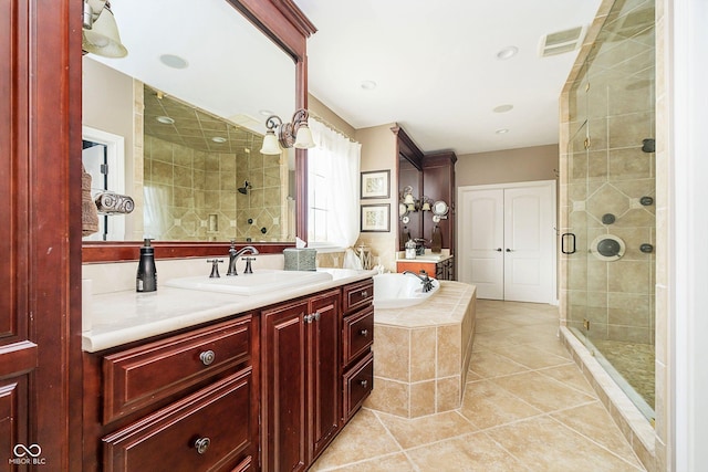 bathroom featuring tile patterned floors, independent shower and bath, and vanity