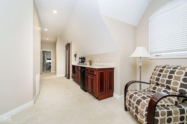 sitting room featuring vaulted ceiling and light carpet