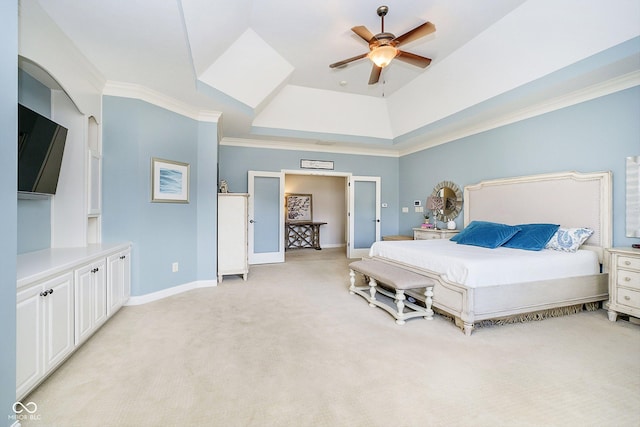 bedroom featuring ornamental molding, light colored carpet, ceiling fan, and a tray ceiling