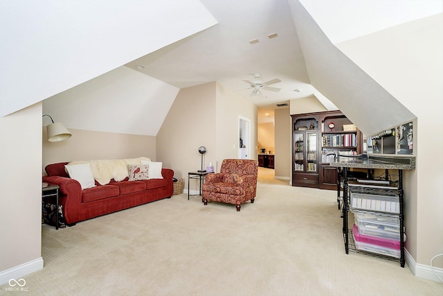 sitting room with ceiling fan, lofted ceiling, and carpet