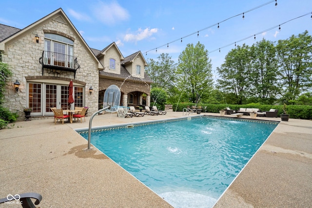 view of pool with a patio, pool water feature, and an outdoor hangout area