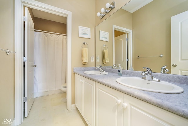 bathroom with vanity, curtained shower, and toilet