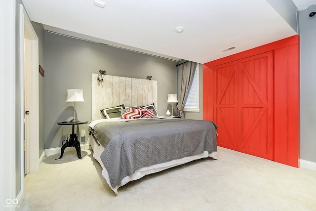 bedroom featuring light carpet