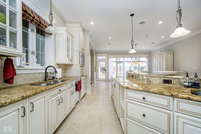 kitchen featuring stainless steel appliances, white cabinetry, sink, and pendant lighting