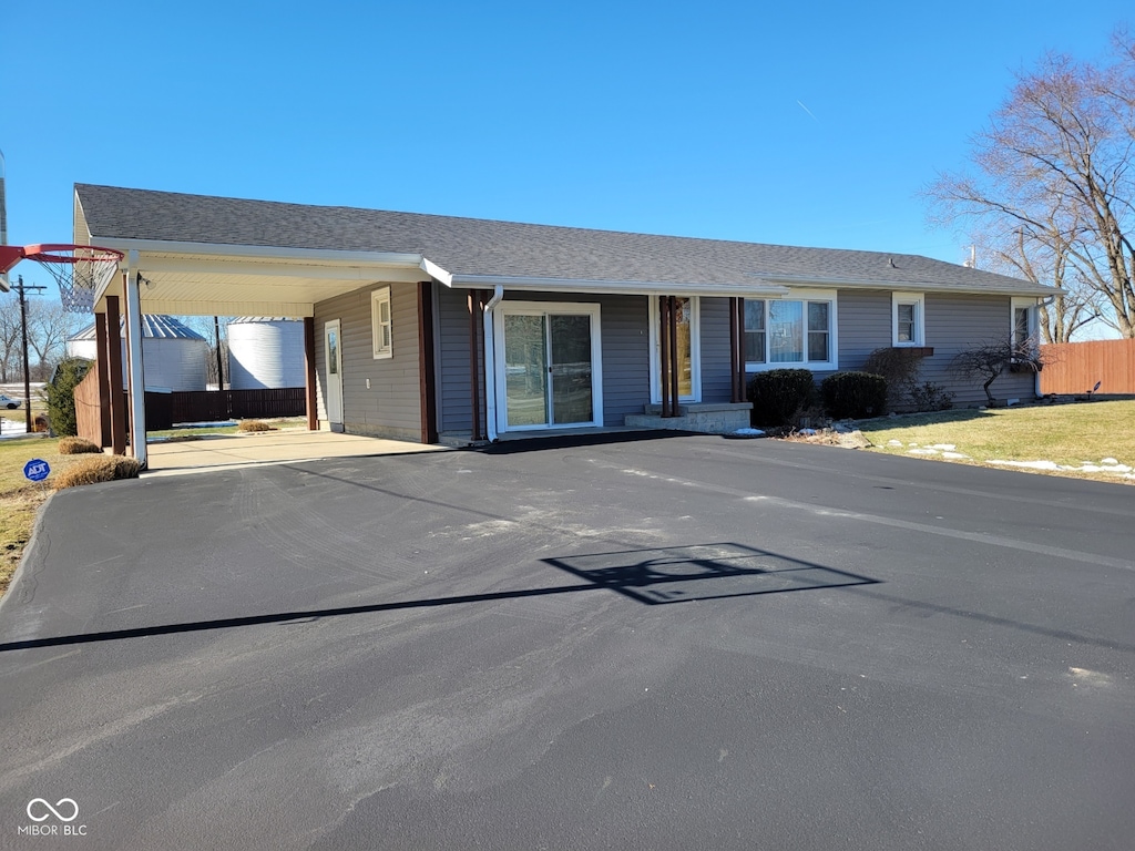 ranch-style home featuring a carport