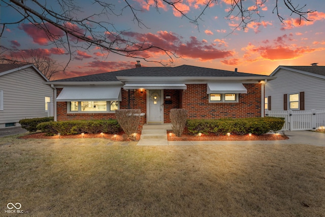 view of front of house with a lawn