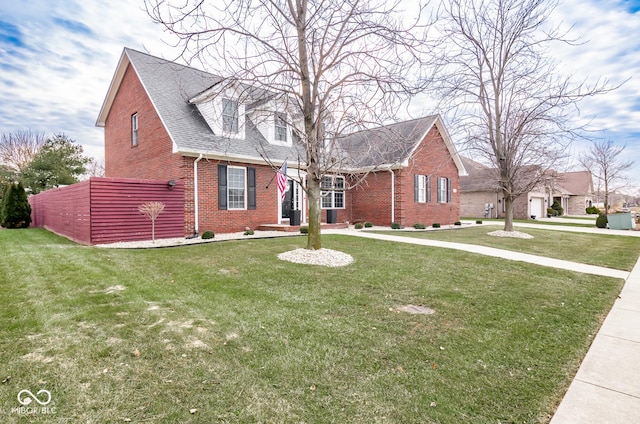 new england style home featuring a front lawn