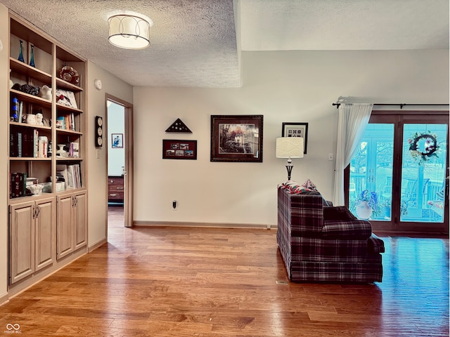 interior space featuring light hardwood / wood-style floors and a textured ceiling