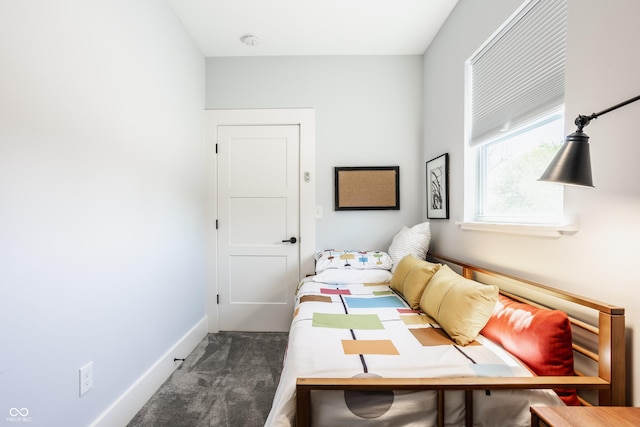 bedroom featuring dark colored carpet