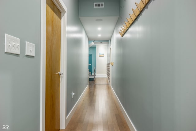 corridor with hardwood / wood-style floors