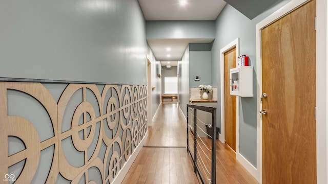 hallway with light hardwood / wood-style flooring