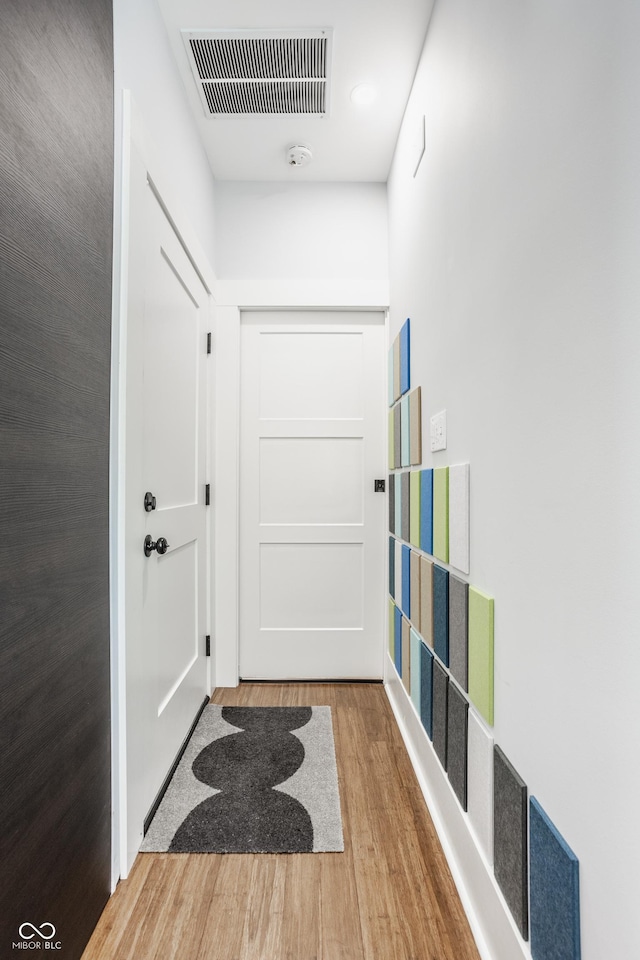 hallway with hardwood / wood-style flooring