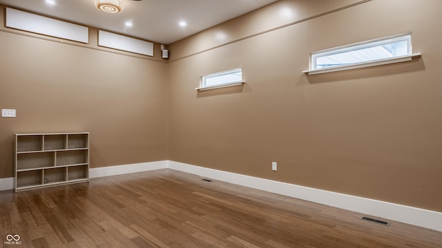 basement with hardwood / wood-style floors