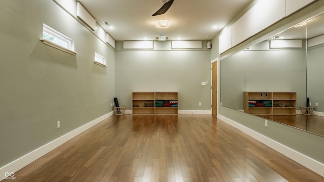 interior space featuring wood-type flooring and ceiling fan