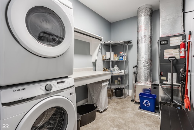 clothes washing area featuring stacked washer / dryer