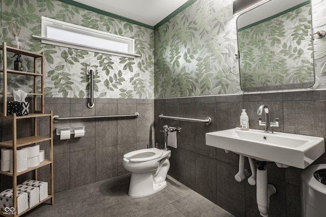 bathroom with sink, tile walls, ornamental molding, toilet, and tile patterned floors