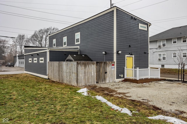 rear view of property with a yard