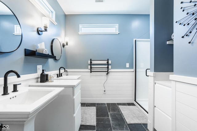 bathroom featuring an enclosed shower and sink