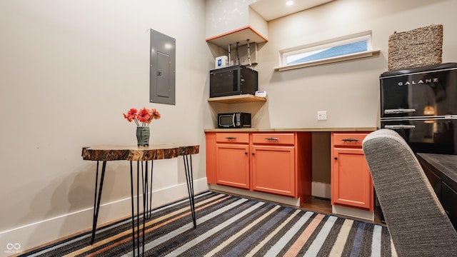 kitchen with black fridge and electric panel