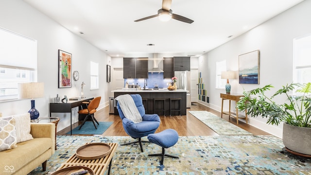 living room featuring ceiling fan and light wood-type flooring