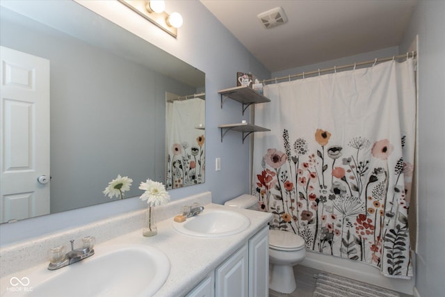 full bathroom featuring a sink, visible vents, toilet, and double vanity