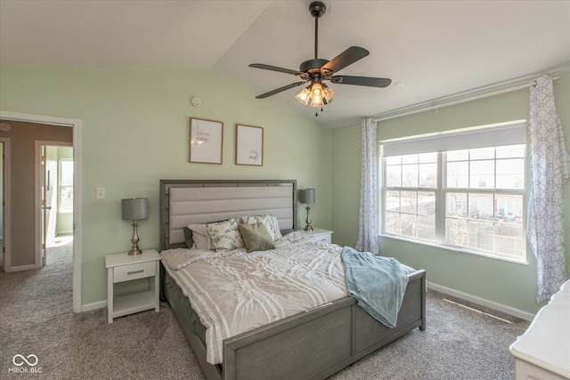 carpeted bedroom featuring vaulted ceiling, a ceiling fan, and baseboards