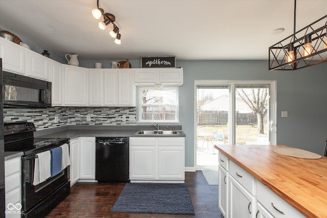 kitchen with backsplash, black appliances, butcher block countertops, white cabinetry, and a sink