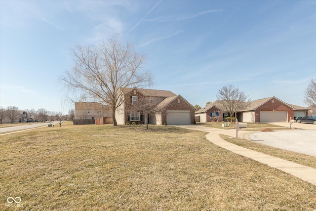 view of front of home with driveway, an attached garage, and a front yard