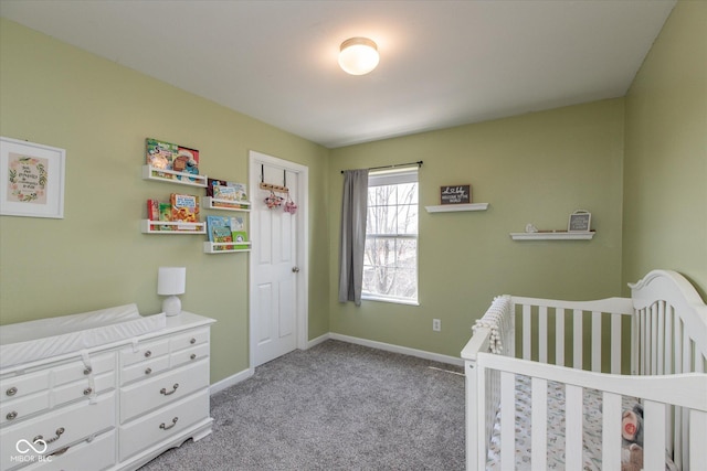 bedroom featuring a nursery area, light colored carpet, and baseboards