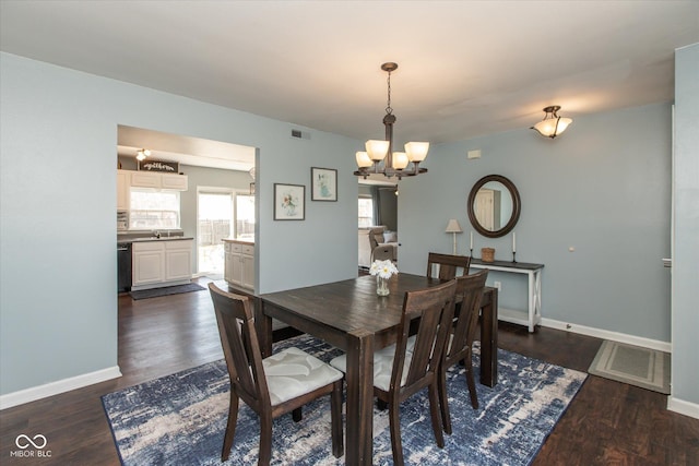 dining room with visible vents, baseboards, a notable chandelier, and dark wood-style flooring