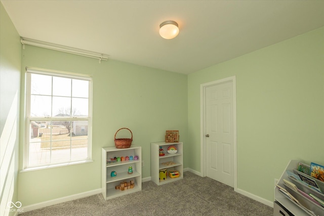 recreation room with baseboards and carpet floors