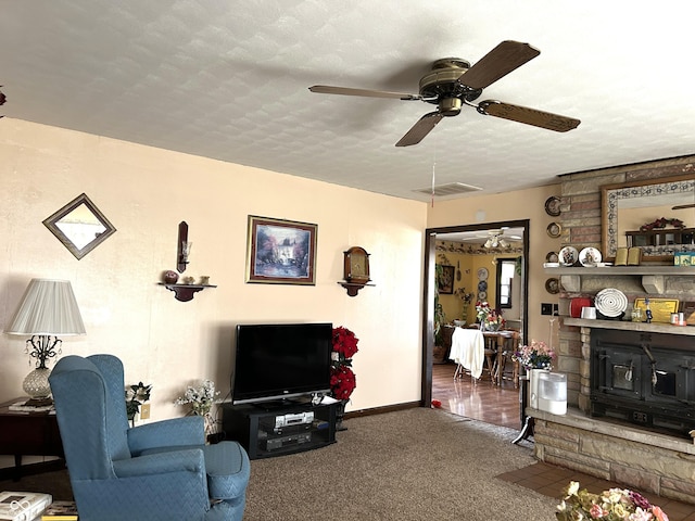 carpeted living room with ceiling fan and a textured ceiling