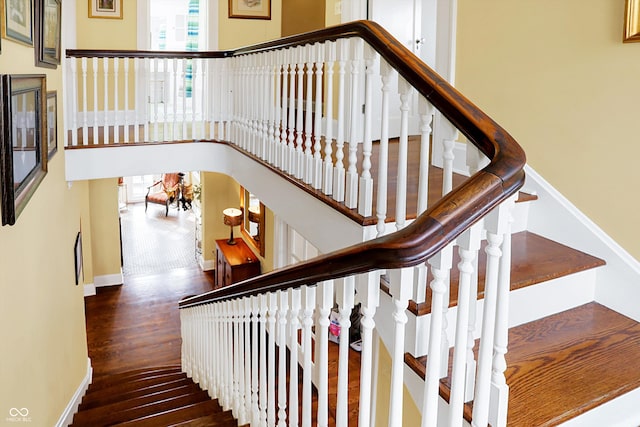 stairs with baseboards and wood finished floors