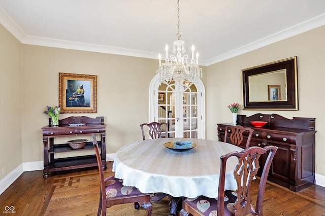 dining space featuring crown molding, baseboards, wood finished floors, and french doors