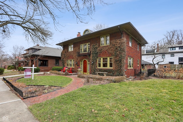 view of front facade featuring brick siding, fence, a chimney, and a front lawn