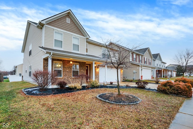 front facade with a garage, a front yard, and a porch