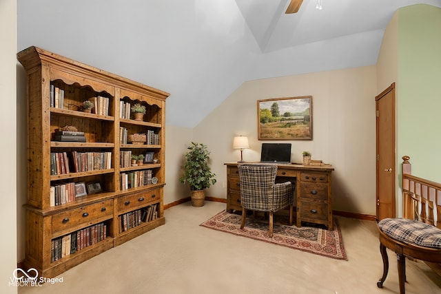 carpeted office space featuring lofted ceiling and ceiling fan