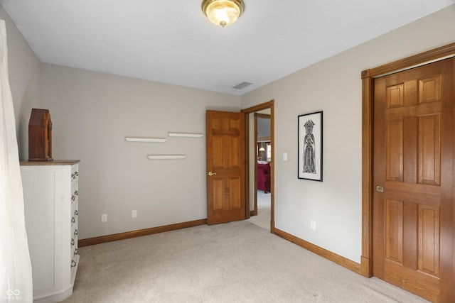 unfurnished bedroom featuring light colored carpet