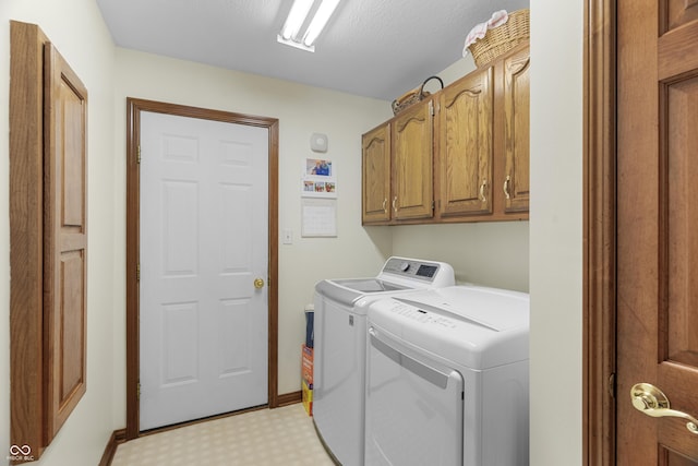 laundry room with cabinets and washing machine and clothes dryer